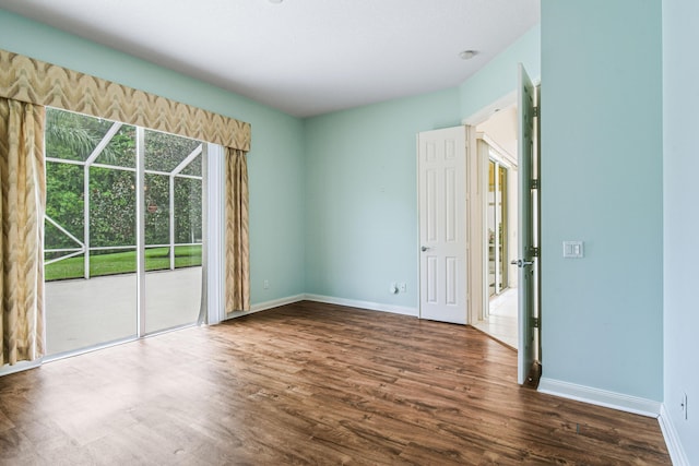 unfurnished room with dark wood-type flooring