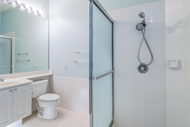 bathroom with tile patterned flooring, vanity, toilet, and walk in shower