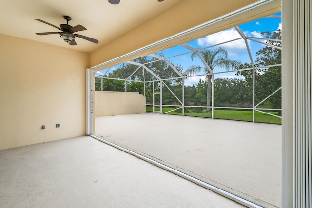 view of patio / terrace with ceiling fan and a lanai