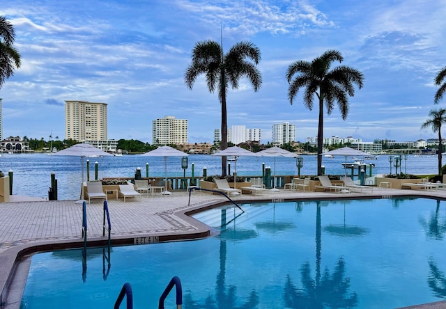 view of swimming pool with a water view