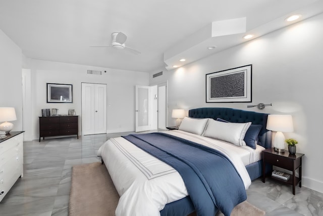 bedroom with light tile patterned flooring, a closet, and ceiling fan