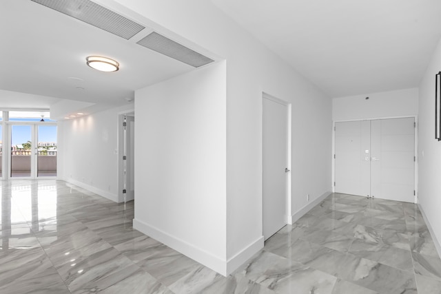 corridor featuring light tile patterned flooring