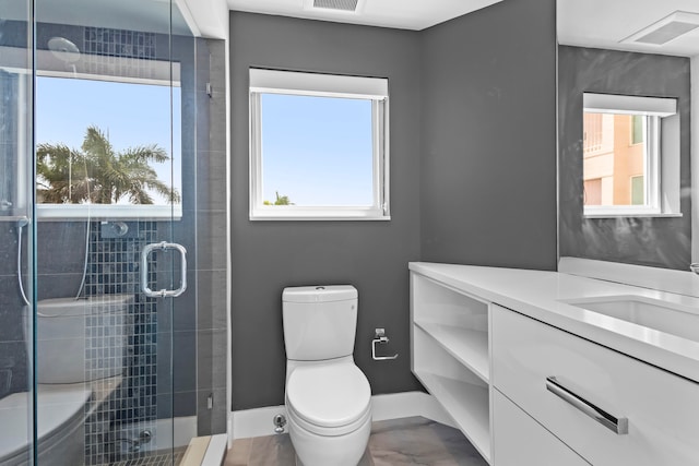 bathroom with vanity, an enclosed shower, and toilet