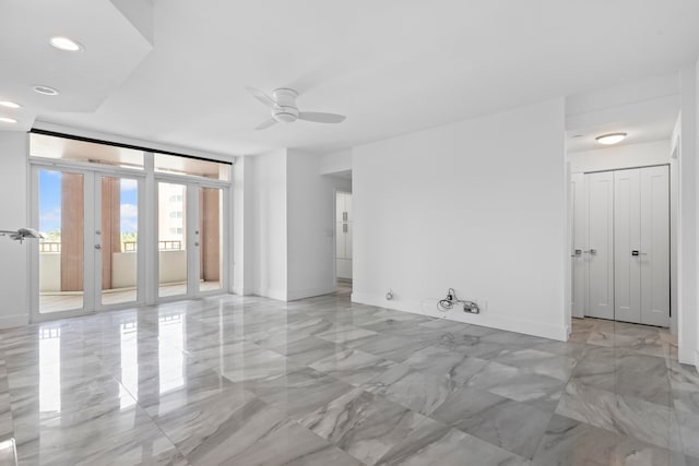 tiled empty room with ceiling fan and french doors