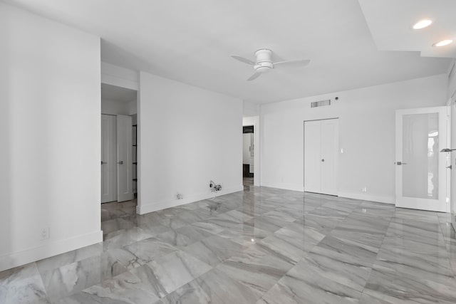 tiled spare room with ceiling fan