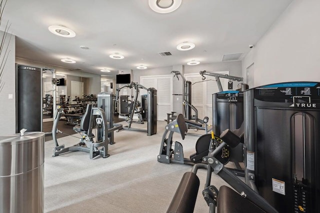 workout area featuring light colored carpet