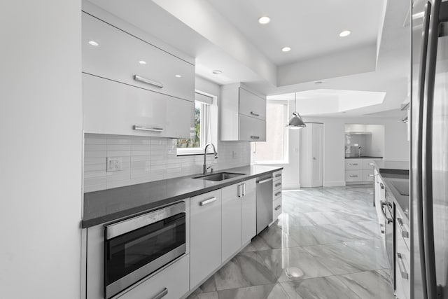 300 SE 5th Ave Unit 5180, Boca Raton, FL 33432 - kitchen featuring a sink, appliances with stainless steel finishes, white cabinetry, dark countertops, and recessed lighting
