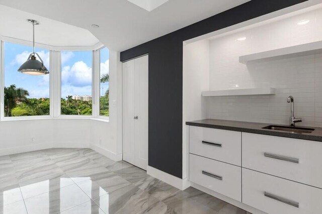 300 SE 5th Ave Unit 5180, Boca Raton, FL 33432 - unfurnished dining area with a sink, baseboards, and light marble finish floors