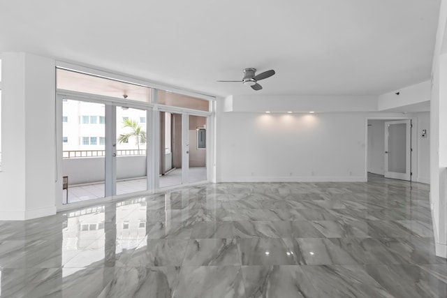 tiled spare room featuring french doors and ceiling fan