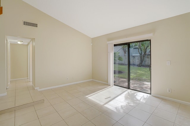 tiled empty room with vaulted ceiling