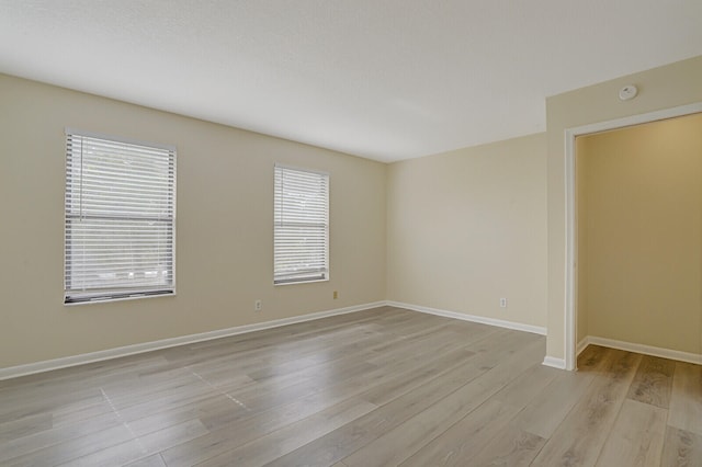 unfurnished room with a wealth of natural light and light hardwood / wood-style floors