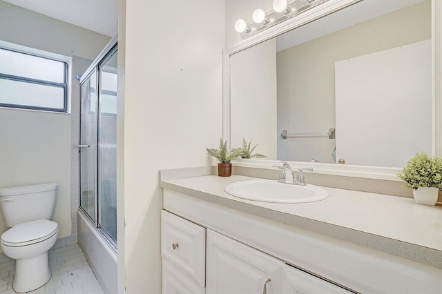 full bathroom with toilet, vanity, tile patterned floors, and enclosed tub / shower combo