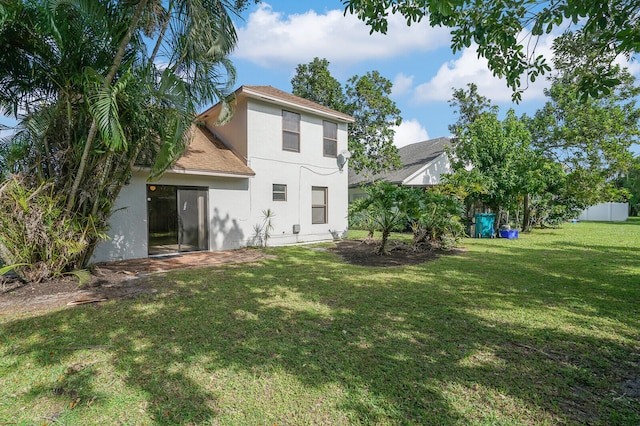 back of house with a yard