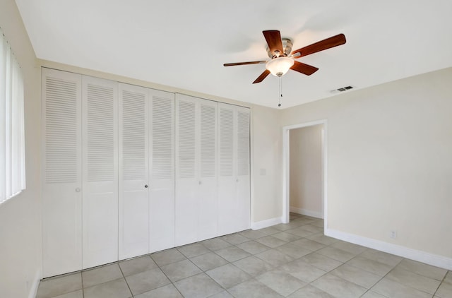 unfurnished bedroom with a closet, ceiling fan, and light tile patterned flooring