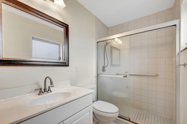 bathroom featuring toilet, vanity, and walk in shower