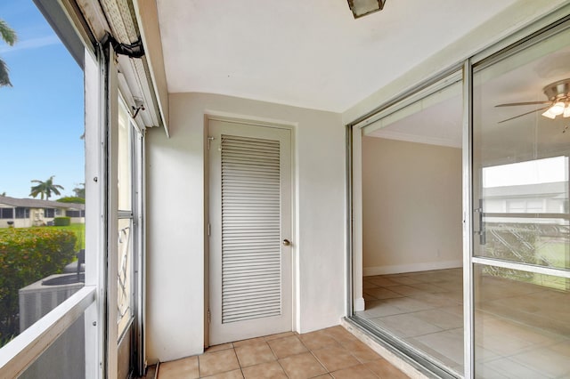 unfurnished sunroom featuring ceiling fan