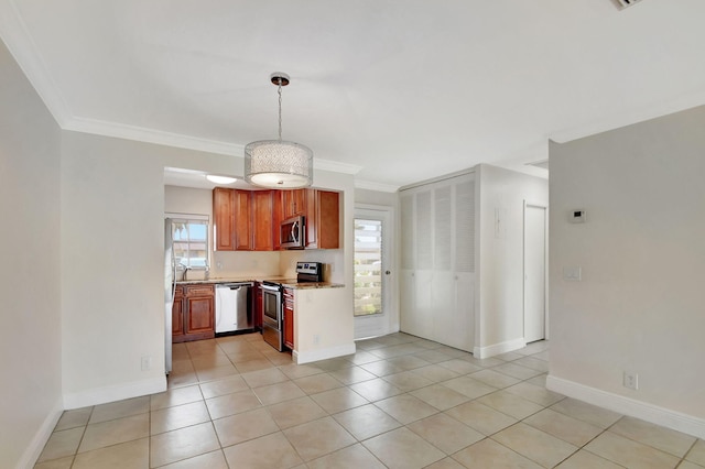 kitchen with crown molding, light tile patterned floors, decorative light fixtures, and appliances with stainless steel finishes