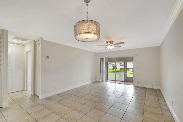 unfurnished room featuring ceiling fan, crown molding, and light tile patterned floors