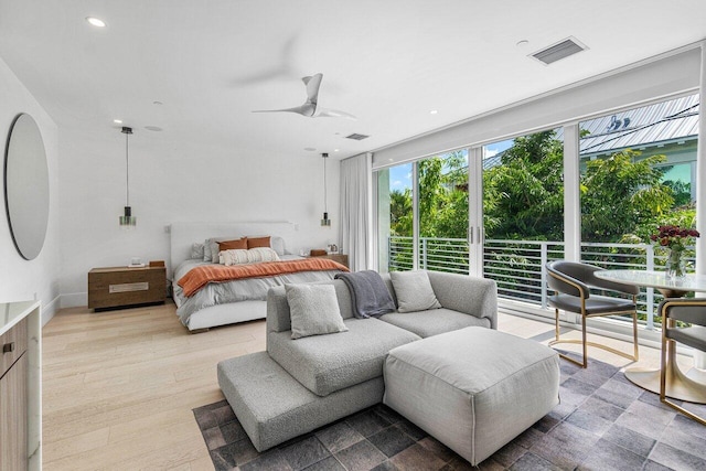 bedroom with a ceiling fan, wood finished floors, visible vents, and recessed lighting