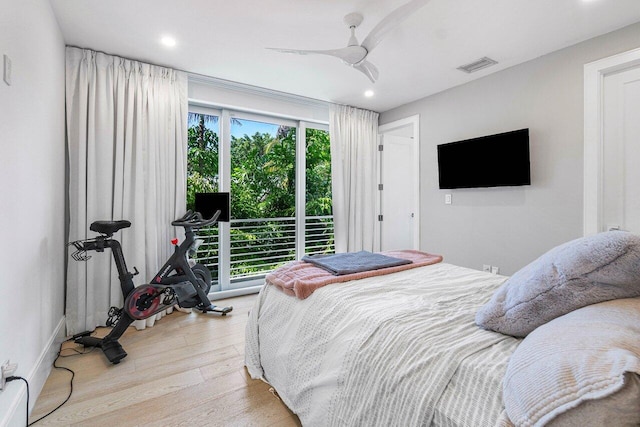 bedroom featuring multiple windows, light wood-type flooring, and ceiling fan