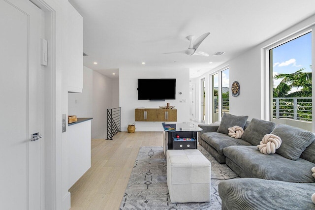 living area with light wood-type flooring, visible vents, a ceiling fan, and recessed lighting