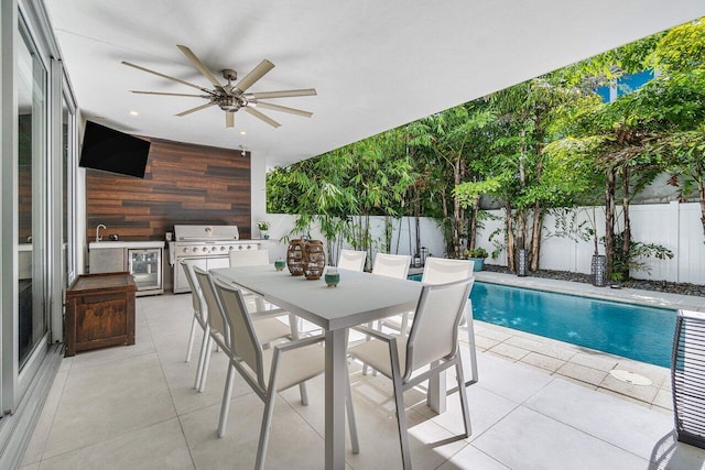 view of patio with a fenced in pool, area for grilling, outdoor dining space, ceiling fan, and a fenced backyard