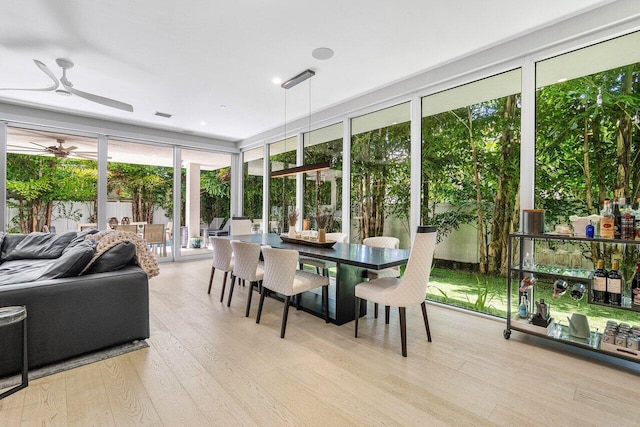 sunroom / solarium with a ceiling fan and visible vents