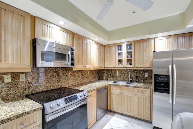 kitchen featuring ceiling fan, sink, appliances with stainless steel finishes, light tile patterned floors, and backsplash