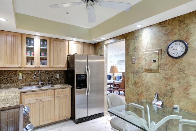 kitchen with sink, decorative backsplash, stainless steel refrigerator with ice dispenser, light tile patterned flooring, and ceiling fan