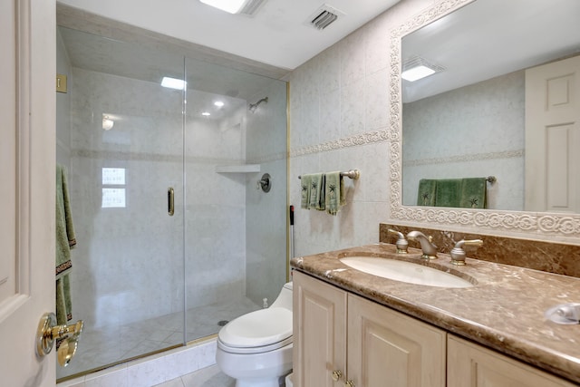 bathroom featuring an enclosed shower, toilet, vanity, tile walls, and tile patterned floors