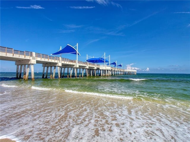 view of property's community with a beach view and a water view