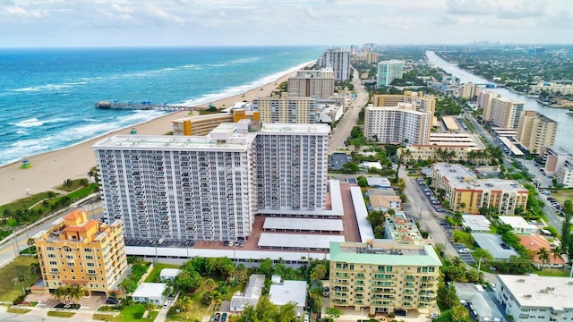 birds eye view of property featuring a water view and a beach view