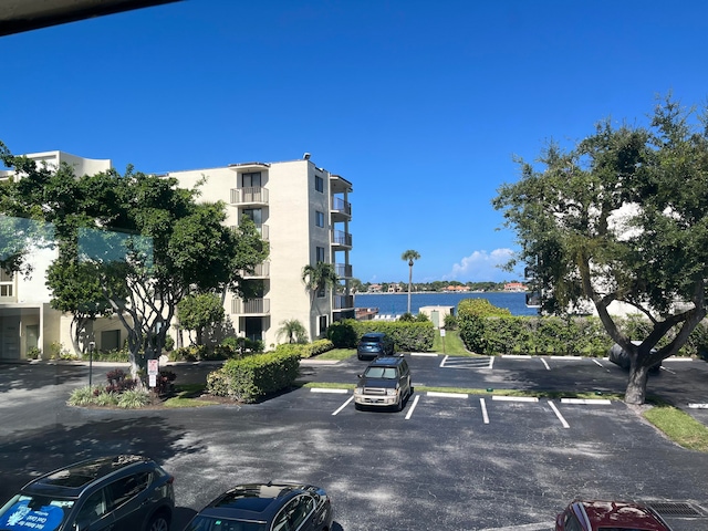 view of vehicle parking featuring a water view