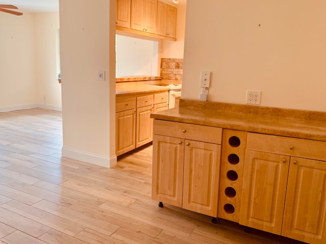 kitchen featuring light brown cabinets, ceiling fan, and light hardwood / wood-style floors