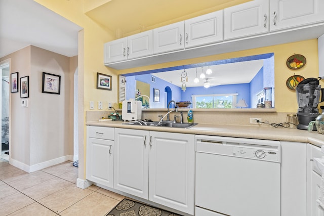 kitchen with sink, light tile patterned flooring, dishwasher, and white cabinets