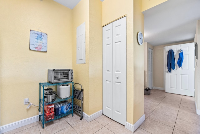 interior space with electric panel and light tile patterned floors