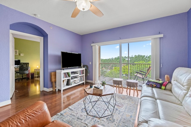 living room featuring ceiling fan and hardwood / wood-style floors