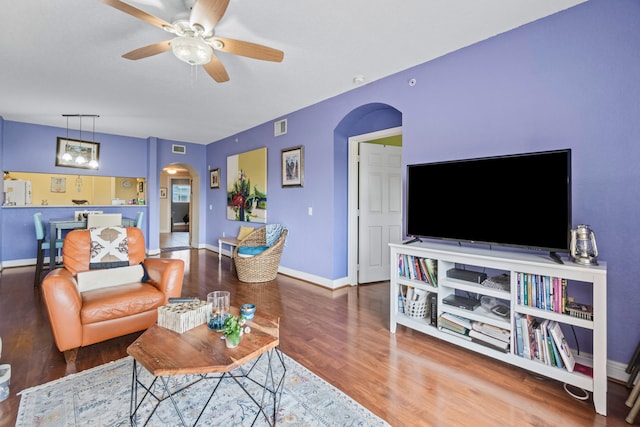 living room with ceiling fan and hardwood / wood-style floors