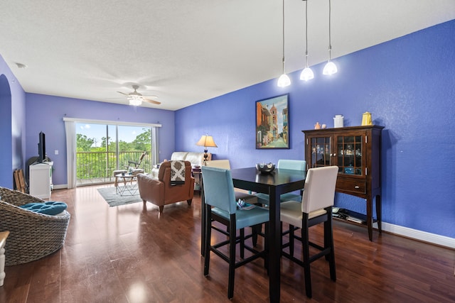 dining area with ceiling fan, a textured ceiling, and hardwood / wood-style flooring