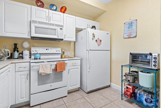 kitchen featuring white cabinets, white appliances, and light tile patterned floors