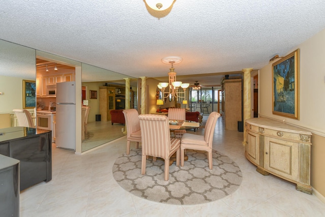 tiled dining area featuring ornate columns, a chandelier, and a textured ceiling