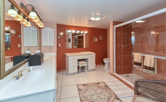 full bath with a stall shower, a sink, toilet, and tile patterned floors