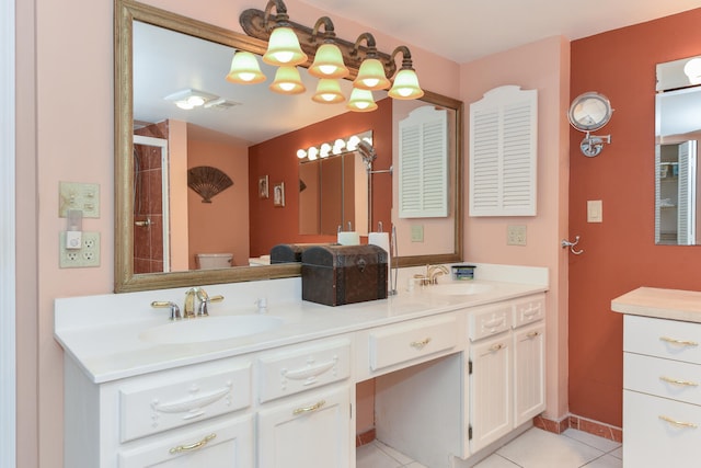 bathroom with toilet, tile patterned flooring, and double vanity