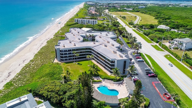 drone / aerial view featuring a view of the beach and a water view