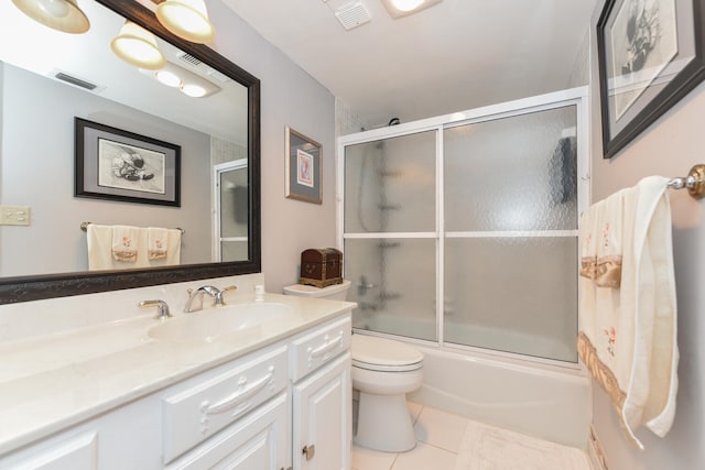 full bathroom featuring vanity, toilet, shower / bath combination with glass door, and tile patterned floors