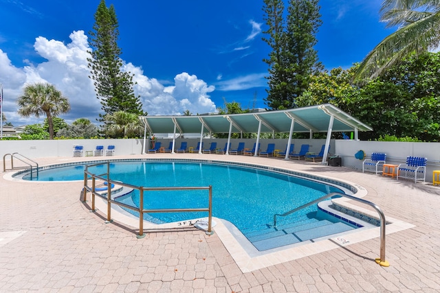 pool featuring a patio area and fence