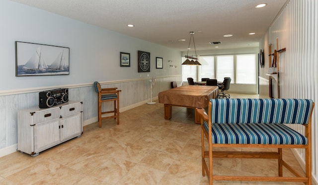 playroom featuring light tile patterned flooring and a textured ceiling