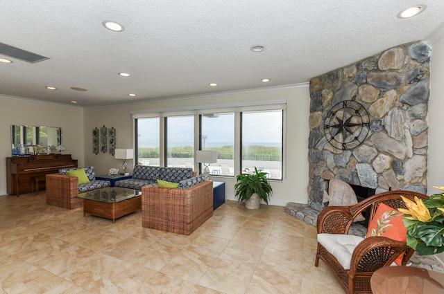 living room featuring a textured ceiling, light tile patterned flooring, a fireplace, and crown molding