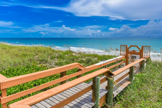 exterior space with a water view and a view of the beach