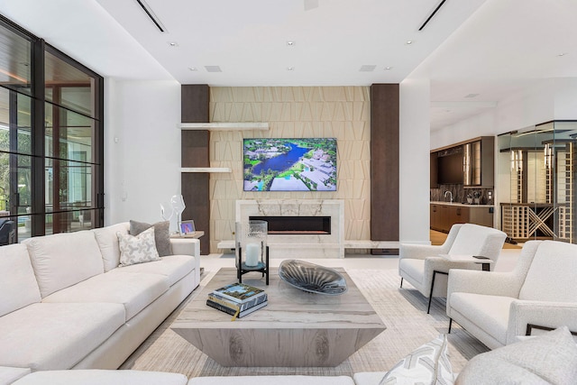 living room featuring a fireplace and sink